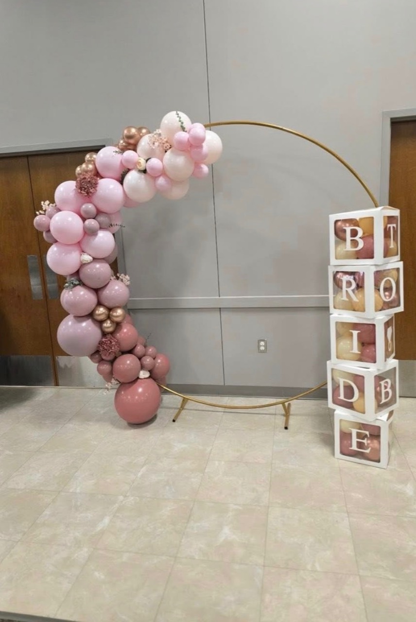 Blush balloon garland on a round gold arch